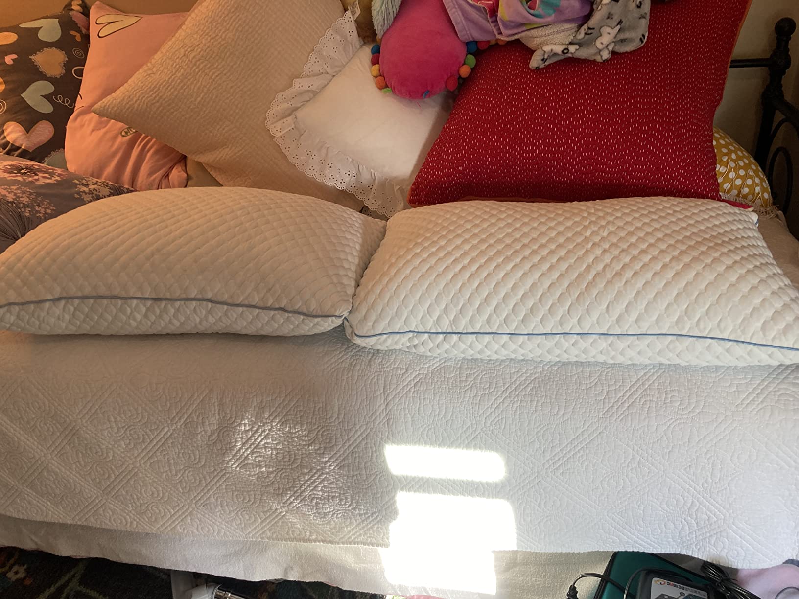 A cozy bed with soft pillows and a stuffed animal, showcasing the VVZ Shredded Pillows in use for a product review.