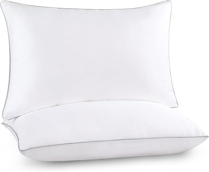 Two Pozino Down Bed Pillows resting on a clean white background, showcasing their soft and inviting appearance.