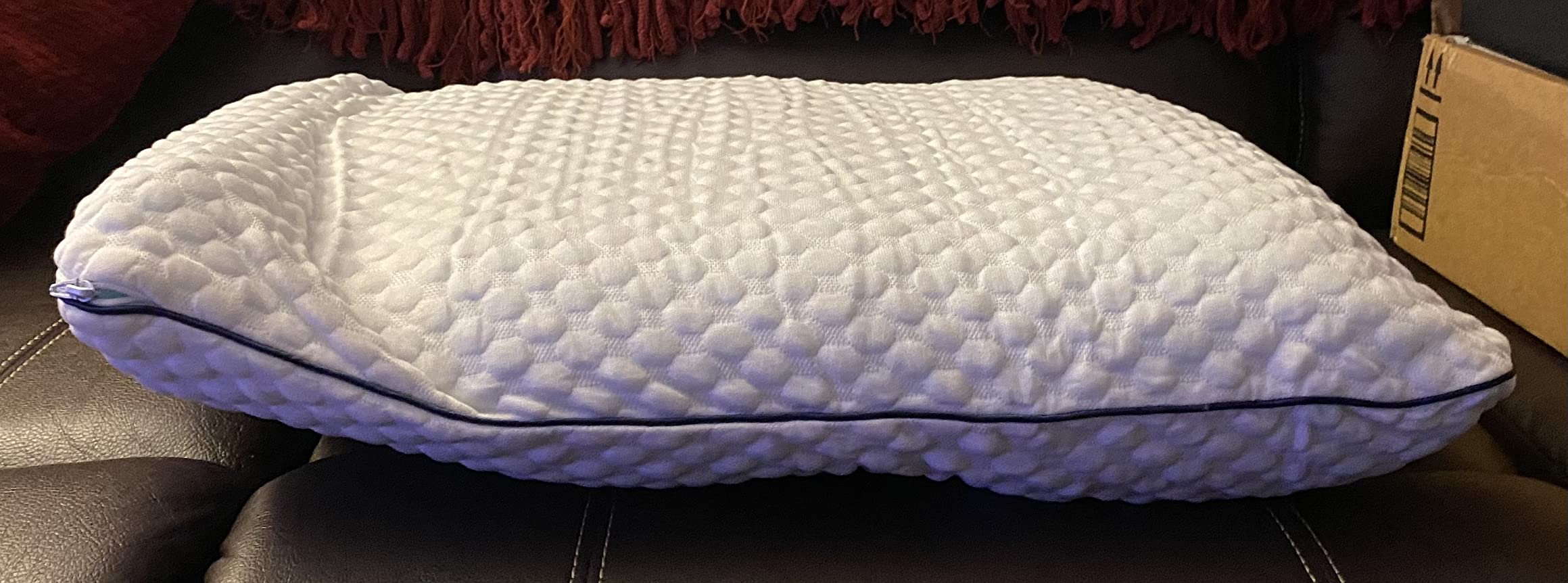 A soft white pillow, the WEEKENDER Gel Memory Foam Pillow, shown in use on a neatly made bed for a product review.