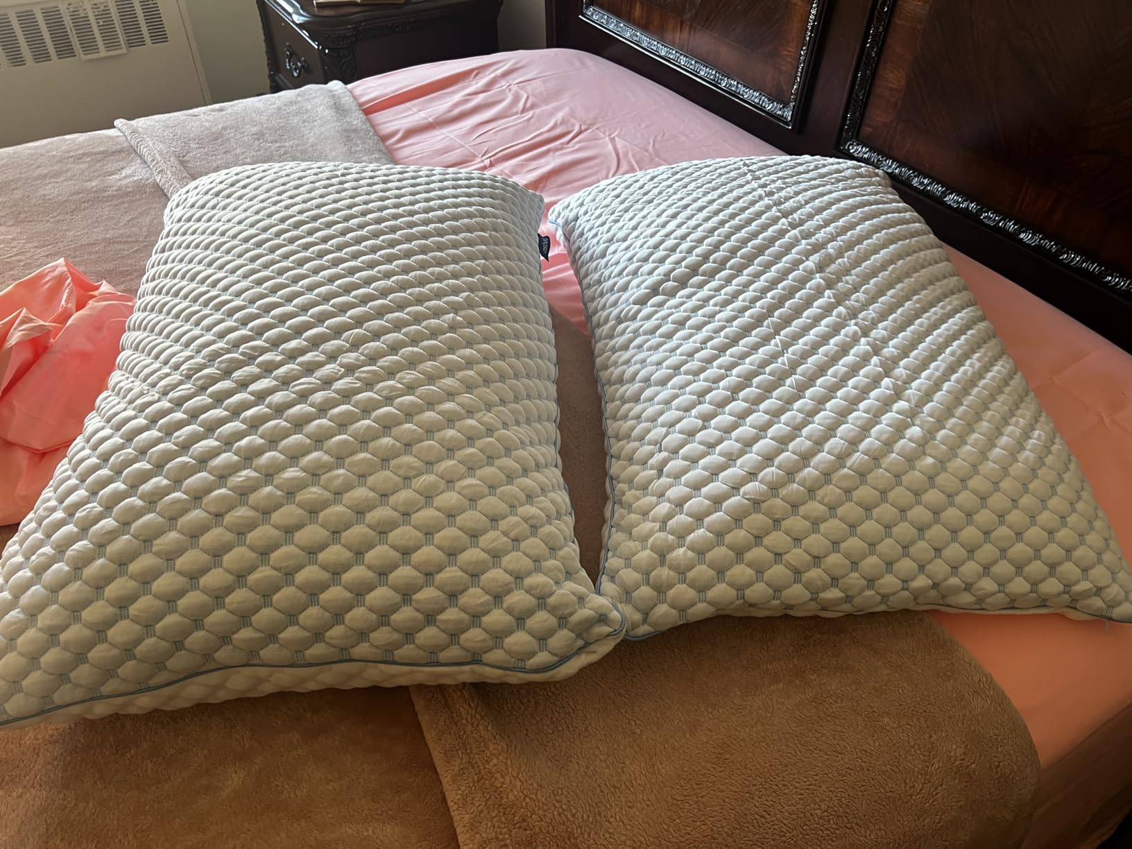 A pair of OSBED Shredded Memory Foam Pillows placed on a bed, highlighting their soft texture and cozy appearance for a review.