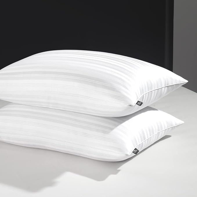 Two luxe Goose Feather Down Pillows resting on a clean white surface, showcasing their soft and inviting appearance.