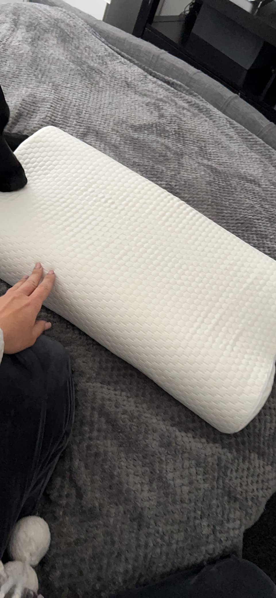 A person is on a bed with a dog on top, comfortably using a Cervical Pillow for Neck Pain during a relaxing moment.
