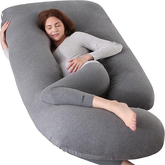 A woman peacefully sleeps on a large gray pillow, the Elover Pregnancy Pillow, providing comfort and support.