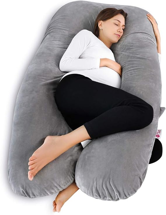 A woman resting on a large gray pillow, enjoying comfort with the Meiz Pregnancy Pillow.